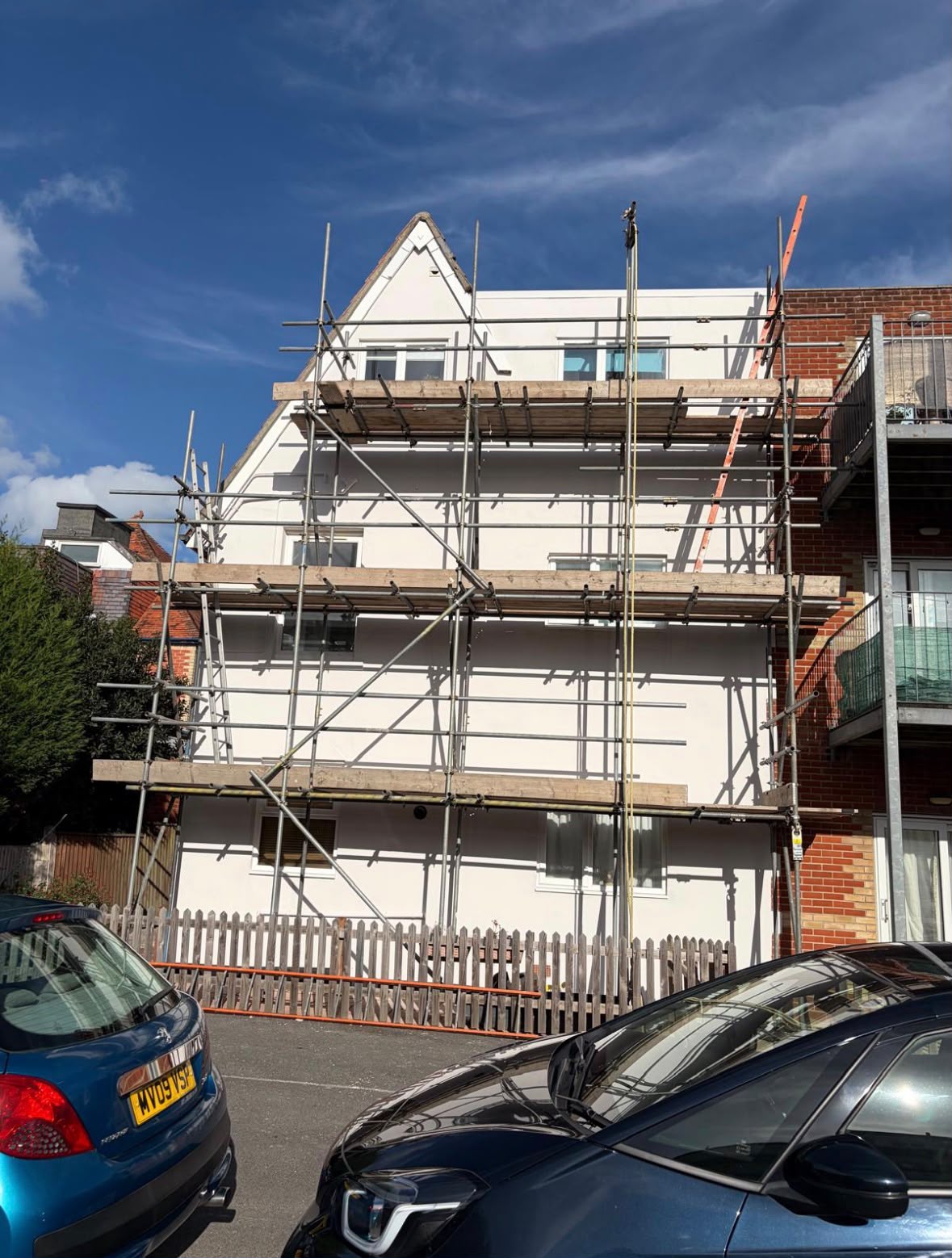 New house extension under construction with scaffolding and timber roof structure