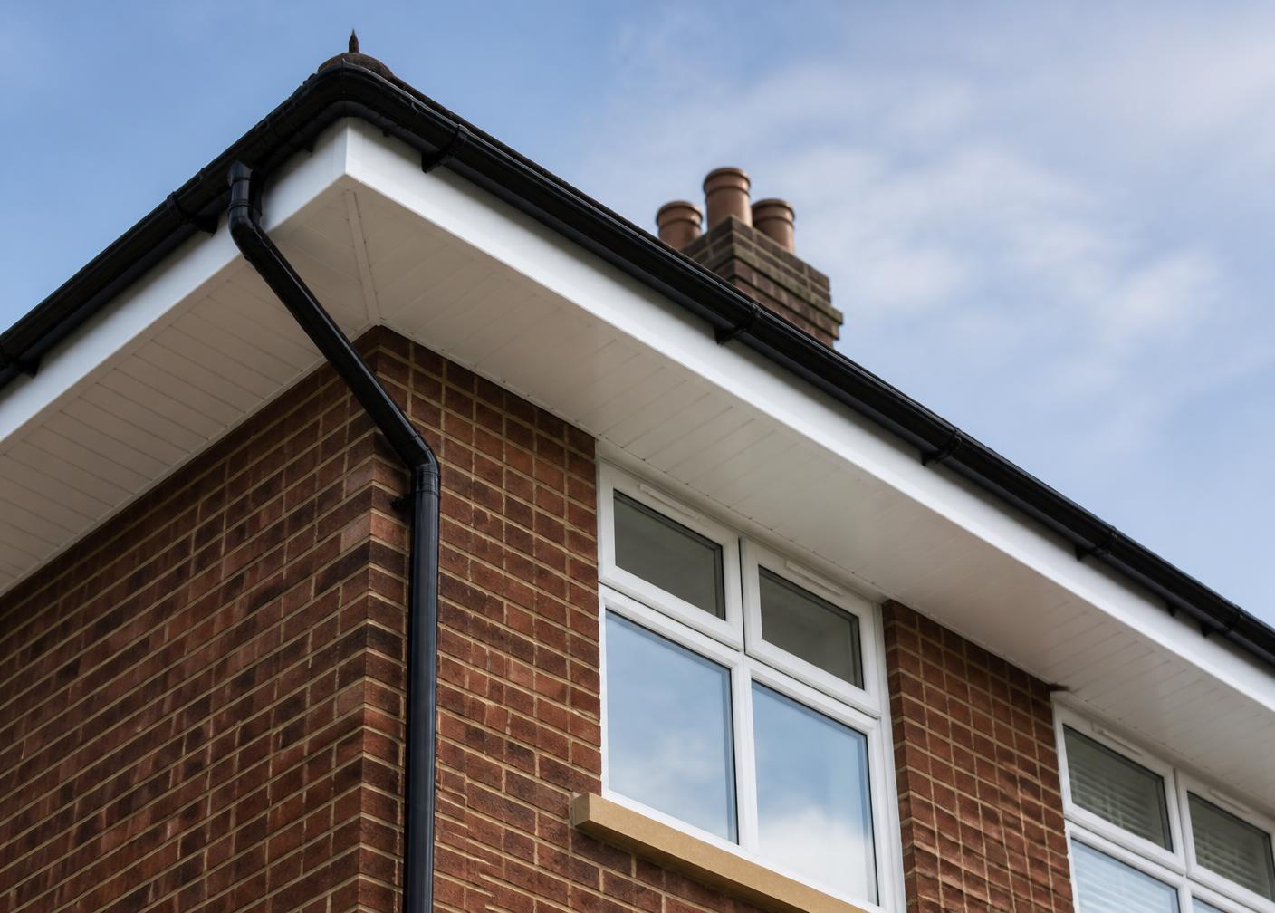 New white fascias, soffits and black guttering on a house